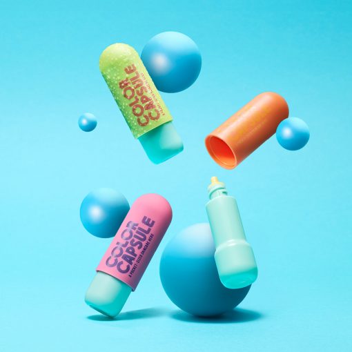 Colorful Color Capsule tottles with PP caps floating against a blue background, showcasing custom finishes and modern domed designs for portable skincare.